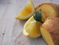 Fresh lemons on a cutting board placed on a wooden table. In the foreground one lemon cut in half. Royalty Free Stock Photo