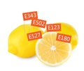 Fresh lemons with E numbers on background. Harmful food additives Royalty Free Stock Photo