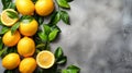 Fresh lemons with leaves on grey concrete background. Top view. Copy space