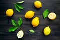 Fresh lemons and lemons leaves on wooden background