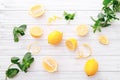 Fresh lemons and mint leaves on white wooden background. Flat lay. Fresh citrus fruit background. Royalty Free Stock Photo