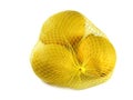 fresh lemons in a yellow net bag isolated on white background Royalty Free Stock Photo