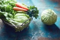 Fresh lettuce, cabbage, spring onions, carrots and parsley in a wire basket Royalty Free Stock Photo