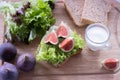 Fresh lettuce and fig sandwich, mug of milk, slices of bread and lettuce, top Royalty Free Stock Photo