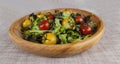 Fresh lettuce and red and yellow cherry tomatoes on a wooden tray Royalty Free Stock Photo