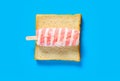 a fresh lichee and milk and grapefruit flavor popsicle on slice of bread