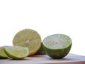 Fresh lime, cut in half and sliced on a wooden cutting board isolated on white background. Royalty Free Stock Photo