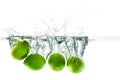 Fresh lime dropped into the water with water splash on a white b Royalty Free Stock Photo