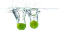 Fresh lime dropped into the water with water splash Royalty Free Stock Photo