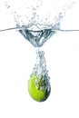 Fresh lime falling into water Royalty Free Stock Photo