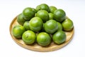 Fresh lime fruits in bamboo basket on white background Royalty Free Stock Photo