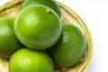 Fresh lime fruits in bamboo basket on white background Royalty Free Stock Photo