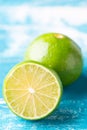 Fresh lime, half on wood background. Green citrus fruit Royalty Free Stock Photo