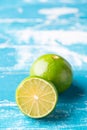 Fresh lime, half on wood background. Green citrus fruit