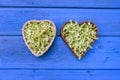 Fresh lime linden tree blossoms in heart shaped wicker baskets Royalty Free Stock Photo