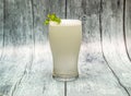 Fresh lime soda juice with mint served in glass isolated on wooden table top view of indian drink Royalty Free Stock Photo