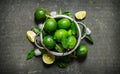 Fresh limes in a saucepan with slices and Royalty Free Stock Photo