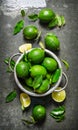 Fresh limes in a saucepan with slices and Royalty Free Stock Photo