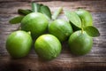 Fresh limes on wooden background. Royalty Free Stock Photo