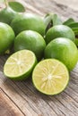 Fresh limes on wooden background.