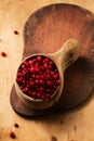 Fresh lingonberries in a wooden Finnish mug