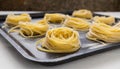 Fresh linguine pasta twirled on sheet pan