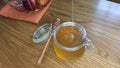 Fresh liquid honey flowing in glass jar. Food concept