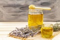 Fresh liquid honey in glass jars with a wooden honey dipper