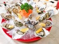 Fresh live raw oyster served with lemon and chili sauce