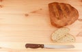 Fresh loaf of bread, cut slices and bread knife Royalty Free Stock Photo