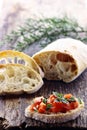 Fresh Loaf of Ciabatta Bread , Sliced on a Wooden Board