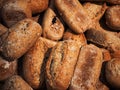 Fresh loaves of bread and buns in rustic bakery, baked goods on rustic background and countryside food market Royalty Free Stock Photo