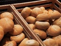 Fresh loaves of bread and buns in rustic bakery, baked goods on rustic background and countryside food market Royalty Free Stock Photo