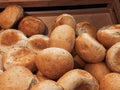 Fresh loaves of bread and buns in rustic bakery, baked goods on rustic background and countryside food market Royalty Free Stock Photo