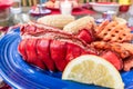 Fresh lobster tail on a plate prepared with butter, corn and potato fries Royalty Free Stock Photo