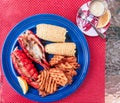 Fresh lobster tail on a plate prepared with butter, corn and potato fries Royalty Free Stock Photo