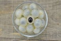 Fresh longan in bowl on wooden background