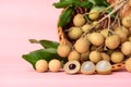 Fresh longan fruit in a basket on pink background