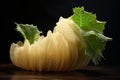 Fresh loofah gourd with leaves on dark background