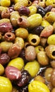 Fresh loose bulk mediterranean black, green and red olives in liquid Royalty Free Stock Photo