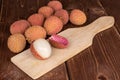 Fresh lychee fruit on brown wood