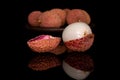 Fresh lychee fruit isolated on black glass