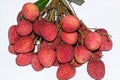 Fresh lychees. A bunch of red ripe lychees on white background