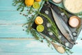 Fresh mackerel on a black slate stone with spices, herbs, lemon, lime and salt. Top view, space for copy Royalty Free Stock Photo