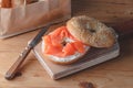 Fresh made Bagel with Salmon on old wooden table