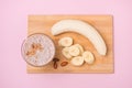 Fresh made banana smoothie in a glass on pink background Royalty Free Stock Photo