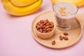 Fresh made banana smoothie in a glass on pink background Royalty Free Stock Photo