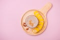 Fresh made banana smoothie in a glass on pink background Royalty Free Stock Photo