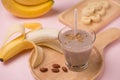 Fresh made Banana smoothie on pink background Royalty Free Stock Photo