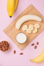 Fresh made Banana smoothie on pink background Royalty Free Stock Photo